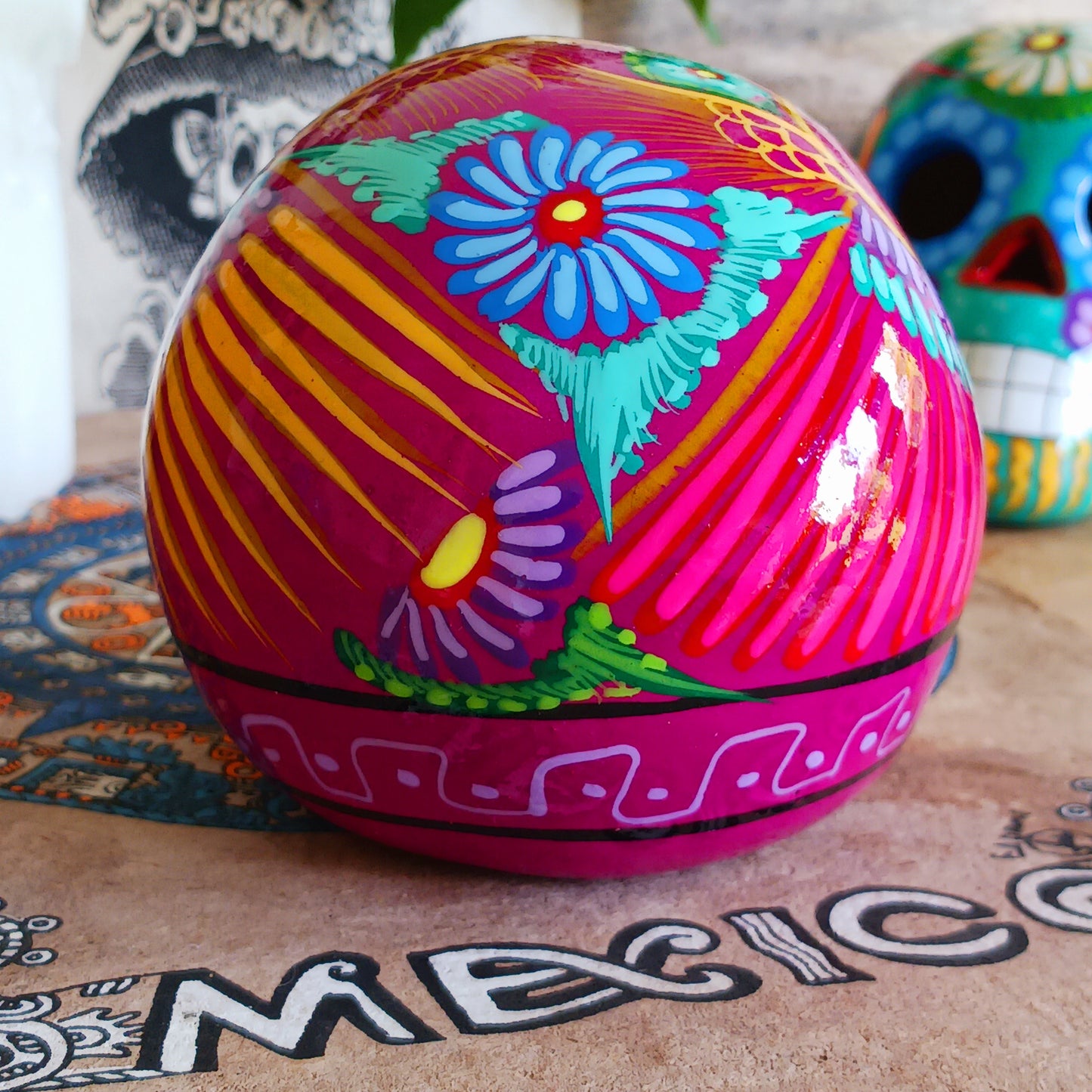 These fun ceramic sugar skull ornaments have been beautifully painted in bright colours and finished with a high shine glaze. They are a popular item during Día de Los Muertos or Day of the Dead festivities, held in Mexico every November to celebrate welcoming the souls of their deceased relatives back for a time of food, drink and celebration.