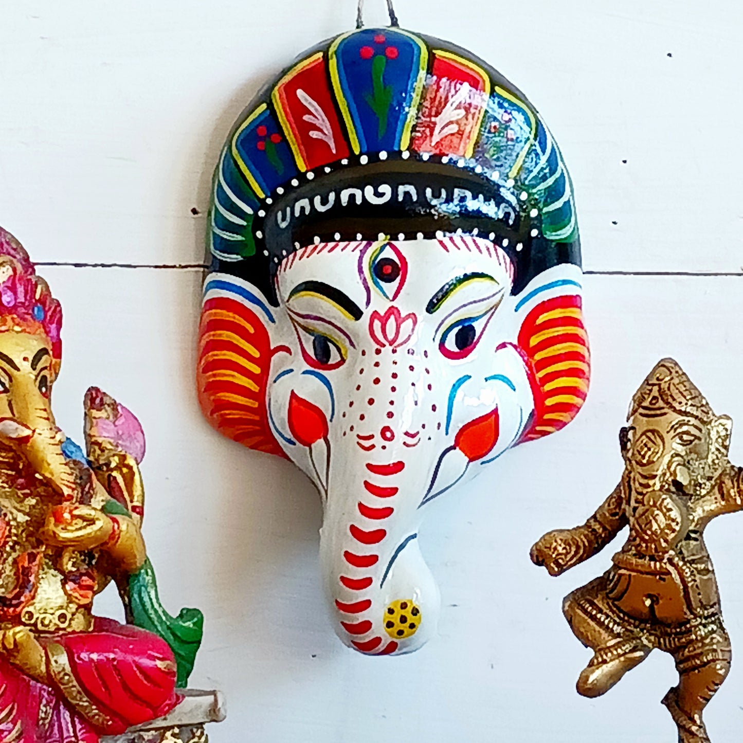 Bring the blessings of Ganesh into your home with this handcrafted terracotta mask from Nepal. Known as the remover of obstacles and the deity of wisdom, learning, and new beginnings, Ganesh is one of the most beloved figures in Hindu tradition. His elephant head and gentle features are beautifully captured in this spiritual wall hanging.