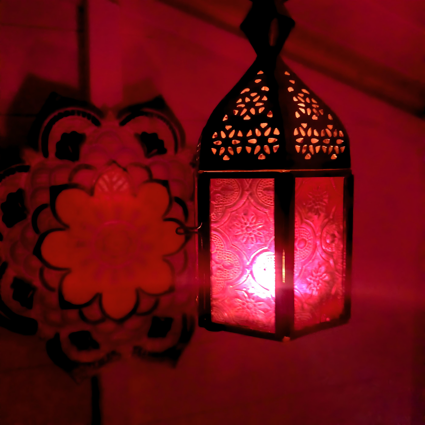 These small glass lanterns come in wonderful colours, featuring an intricate embossed pattern. They have a small hinged door that closes with a sliding catch. The small handle on the top is great for hanging the lanterns around your home. Perfect for adding a touch of warmth to your space.