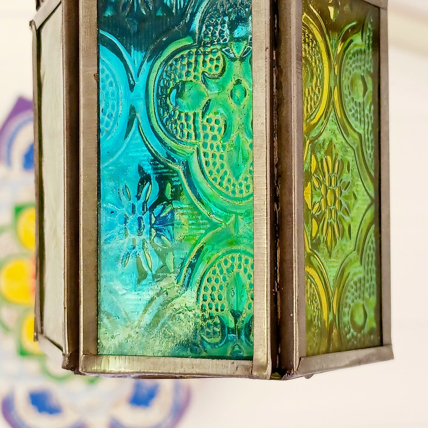 These small glass lanterns come in wonderful colours, featuring an intricate embossed pattern. They have a small hinged door that closes with a sliding catch. The small handle on the top is great for hanging the lanterns around your home. Perfect for adding a touch of warmth to your space.