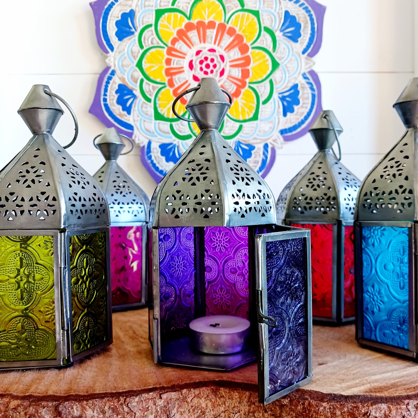 These small Moroccan style glass lanterns come in wonderful colours, featuring an intricate embossed pattern. They have a small hinged door that closes with a sliding catch. The small handle on the top is great for hanging the lanterns around your home. Perfect for adding a touch of warmth to your space.