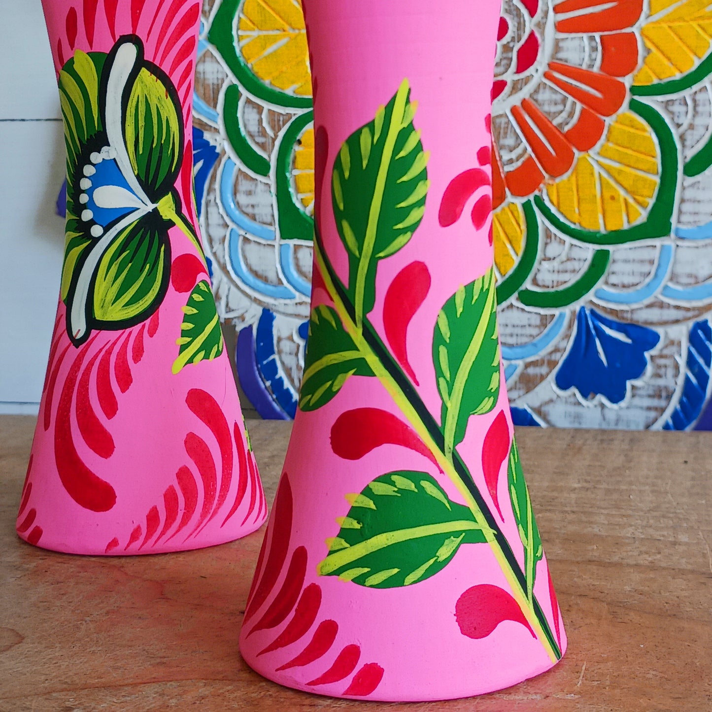 Hand painted in a vibrant pink hue and adorned with the Shapla (waterlily) flower — the national flower of Bangladesh, this fair trade candle holder is a true statement piece. Display it prominently or gift it to someone special as a unique, ethical, and meaningful present. Beautiful on its own or paired with others, it adds warmth, tradition, and cheerful design to any space.