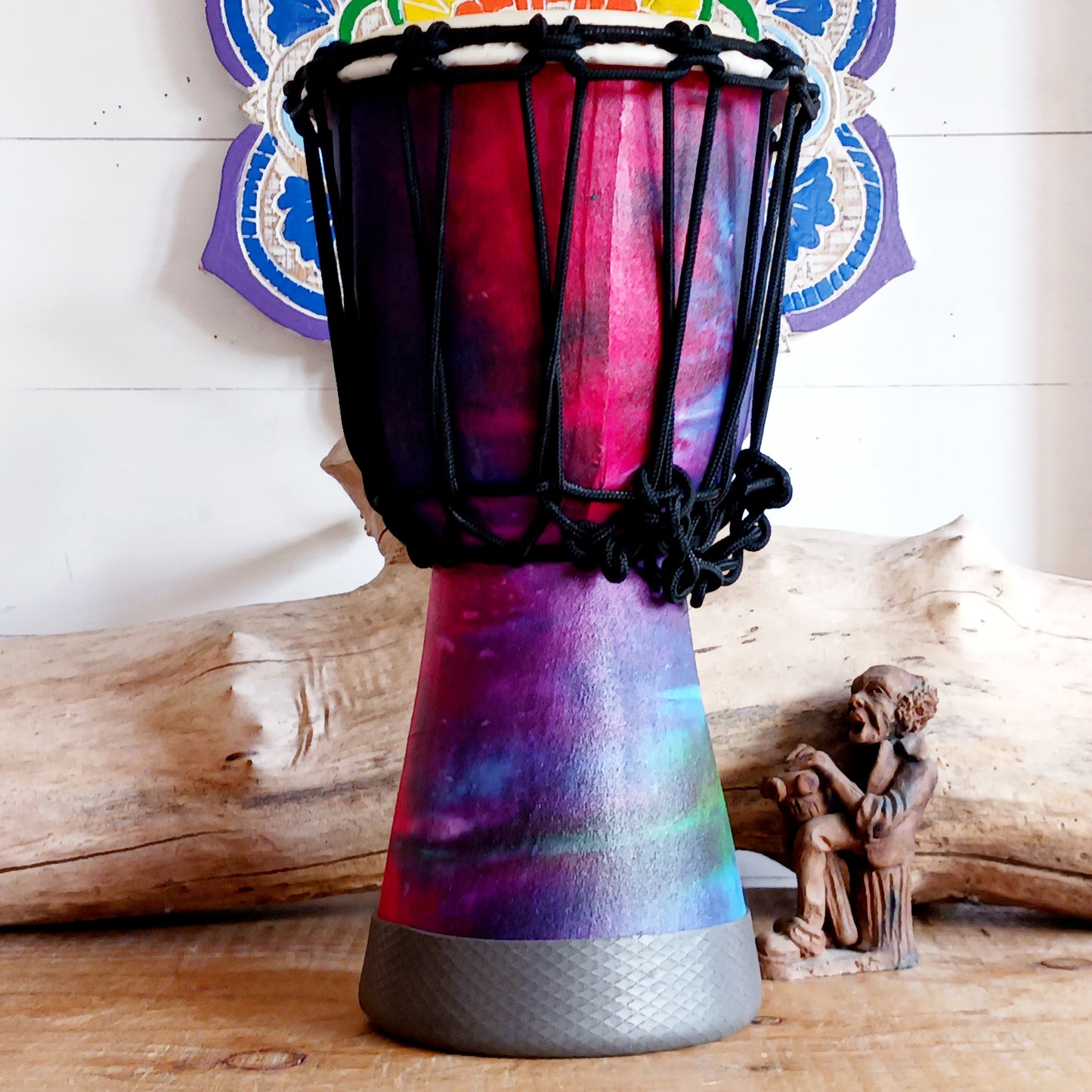 Awaken your rhythm with this handcrafted Rainbow Wooden Djembe from the heart of Indonesia. Standing 30cm tall with a 6–8" head, this compact drum carries the earth’s natural resonance and the spirit of Balinese ceremony. Wrapped in vibrant rainbow sarong fabric and finished with a protective varnish, it radiates healing colour and joyful energy.