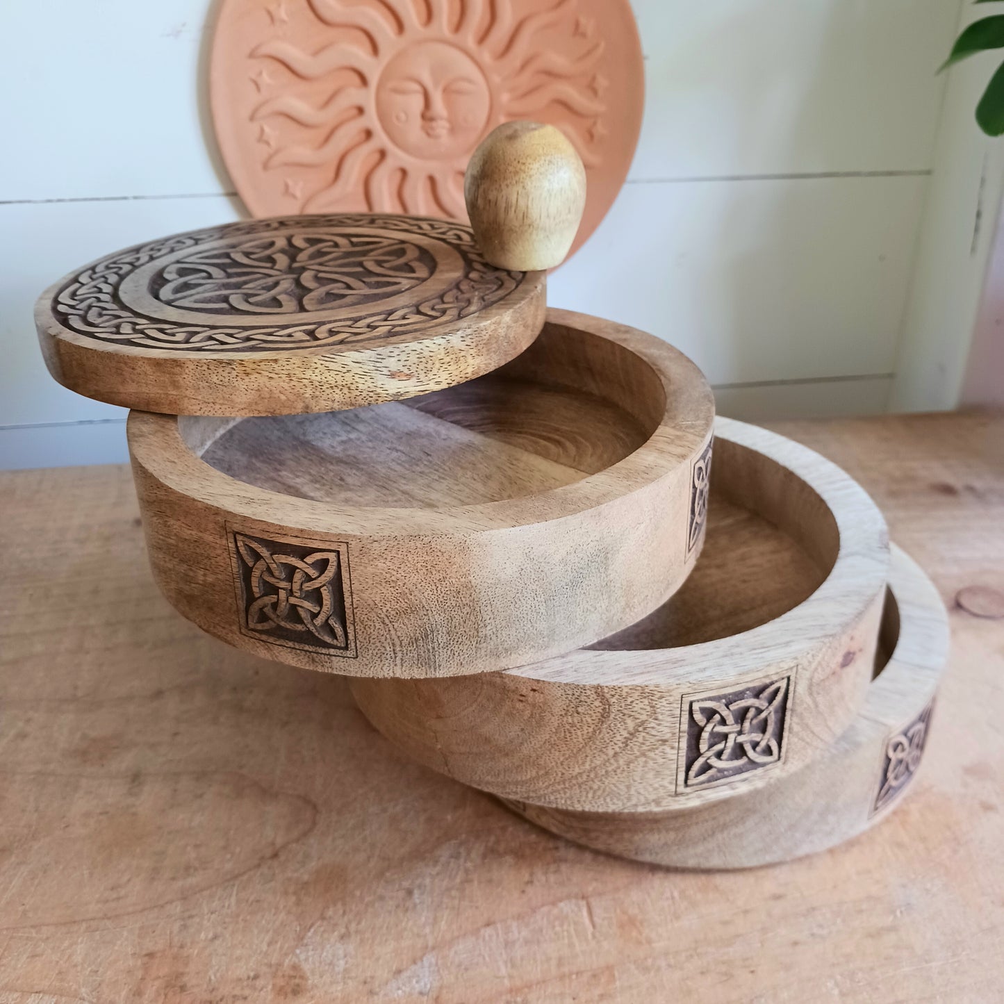 Bring timeless craftsmanship and functional beauty into your space with this Celtic Carved Revolving Storage Box, expertly hand-crafted from sustainable mango wood. Designed with both elegance and practicality in mind, this unique 3-tier swivel box opens smoothly from a central pivot, revealing three spacious compartments that fan out effortlessly.