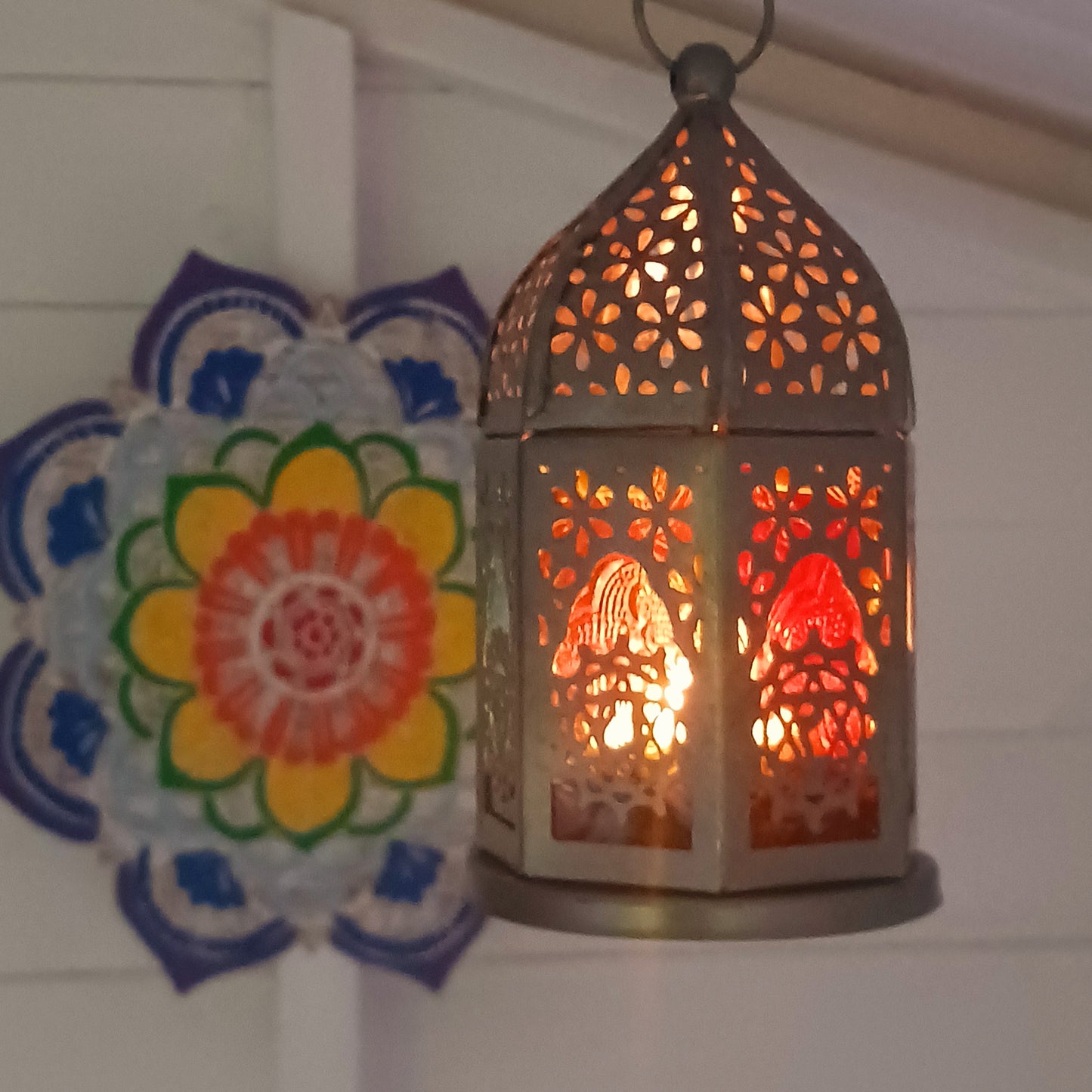 This delightful little seven-sided standing lantern has each side elegantly showcasing a chakra symbol. With a convenient bottom-opening door that doubles as a candle holder tray, this lantern is practical and attractive.