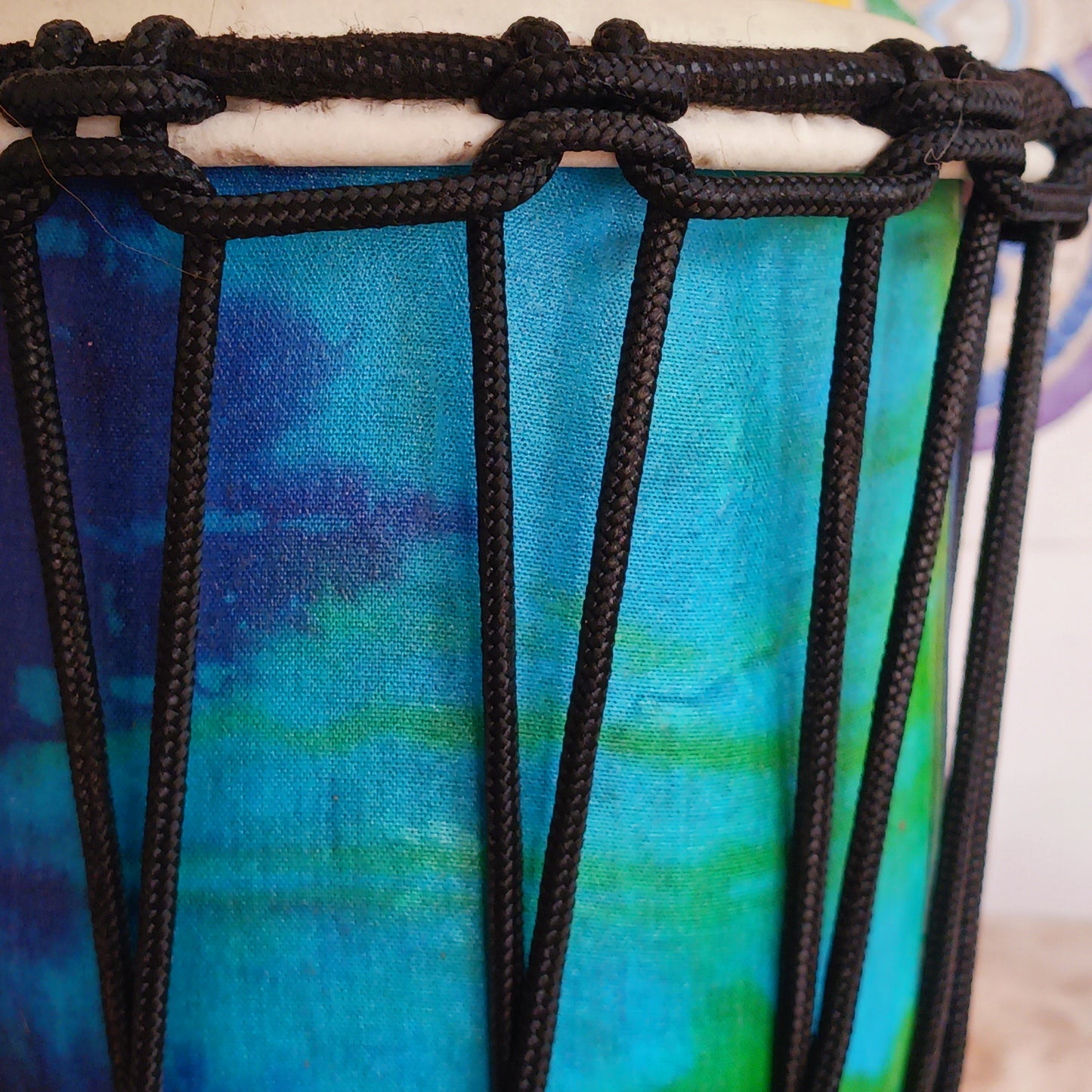 Awaken your rhythm with this handcrafted Rainbow Wooden Djembe from the heart of Indonesia. Standing 30cm tall with a 6–8" head, this compact drum carries the earth’s natural resonance and the spirit of Balinese ceremony. Wrapped in vibrant rainbow sarong fabric and finished with a protective varnish, it radiates healing colour and joyful energy.