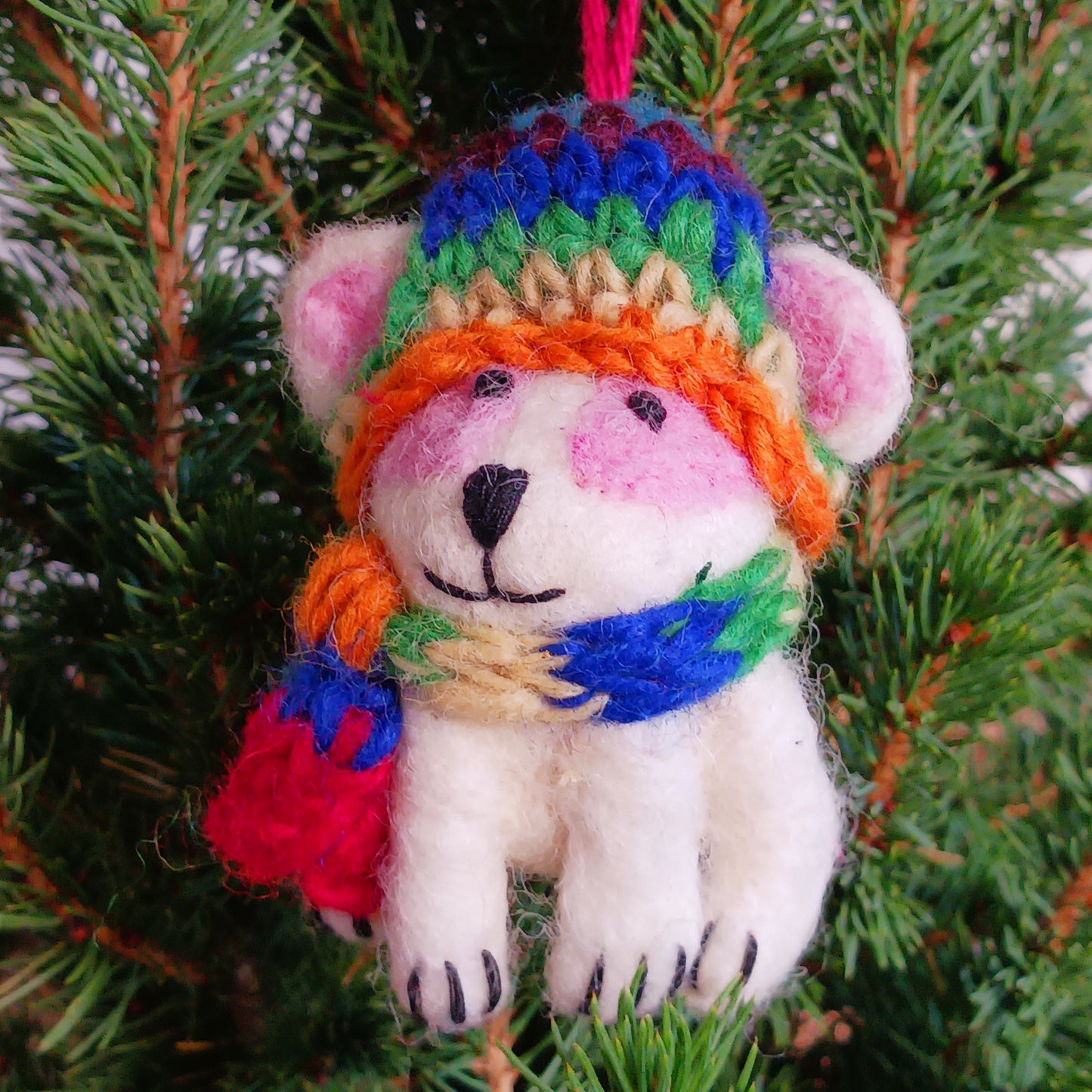 Bring instant festive cheer to your home with this adorable Christmas Tree Rabbit Decoration. Dressed in a hand-knitted rainbow hat and matching scarf, this charming little bunny captures the magic of the season at first sight. Its sweet black nose, expressive eyes, and cartoon-like ears bring out the childlike joy in anyone who sees it.