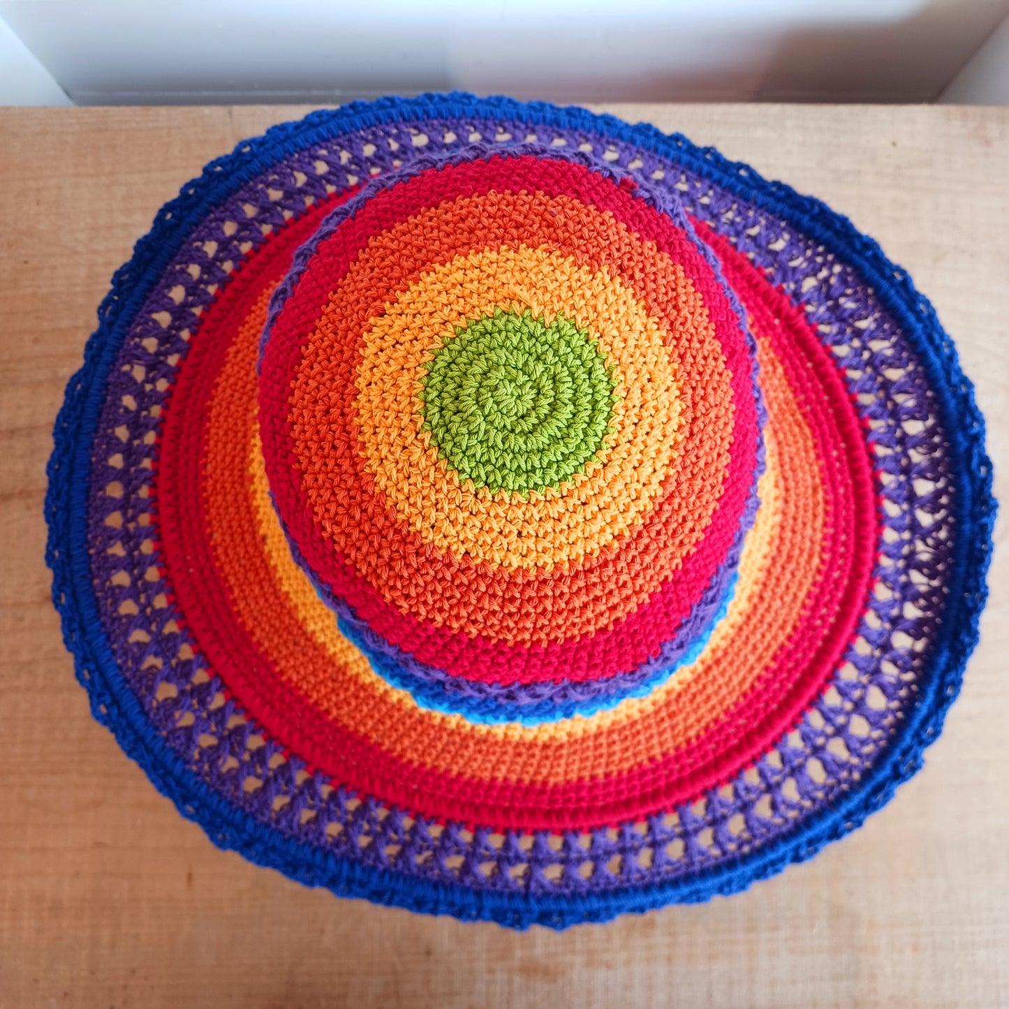 Handmade rainbow crochet sun hat with a flexible brim. Perfect for holidays, beach days & festivals. Unique, lightweight, and ready for sunny adventures!