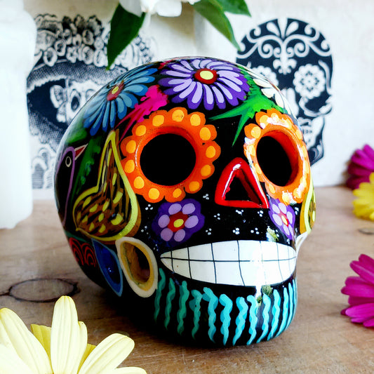 These fun ceramic sugar skull ornaments have been beautifully painted in bright colours and finished with a high shine glaze. They are a popular item during Día de Los Muertos or Day of the Dead festivities, held in Mexico every November to celebrate welcoming the souls of their deceased relatives back for a time of food, drink and celebration.