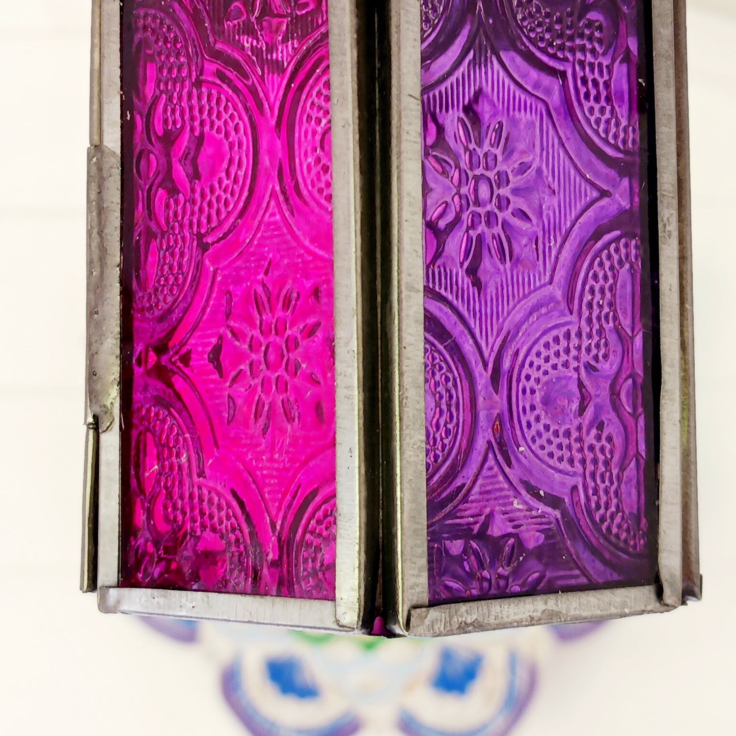These small glass lanterns come in wonderful colours, featuring an intricate embossed pattern. They have a small hinged door that closes with a sliding catch. The small handle on the top is great for hanging the lanterns around your home. Perfect for adding a touch of warmth to your space.