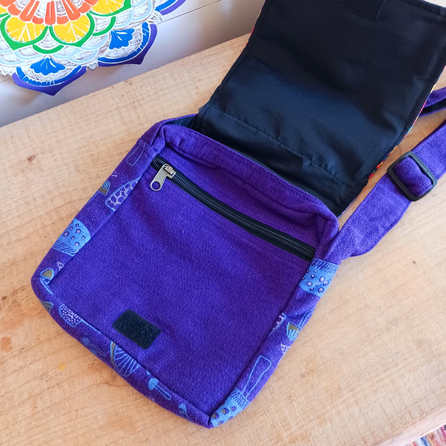 This lovely Yin Yang shoulder bag is both practical and unusual. There are three zipped compartments ensuring you keep your valuables safe. The Yin Yang design on the front is set in a colourful mandala on the flap, and this is secured with a velcro strips. The staps are adjustable to suit your style.