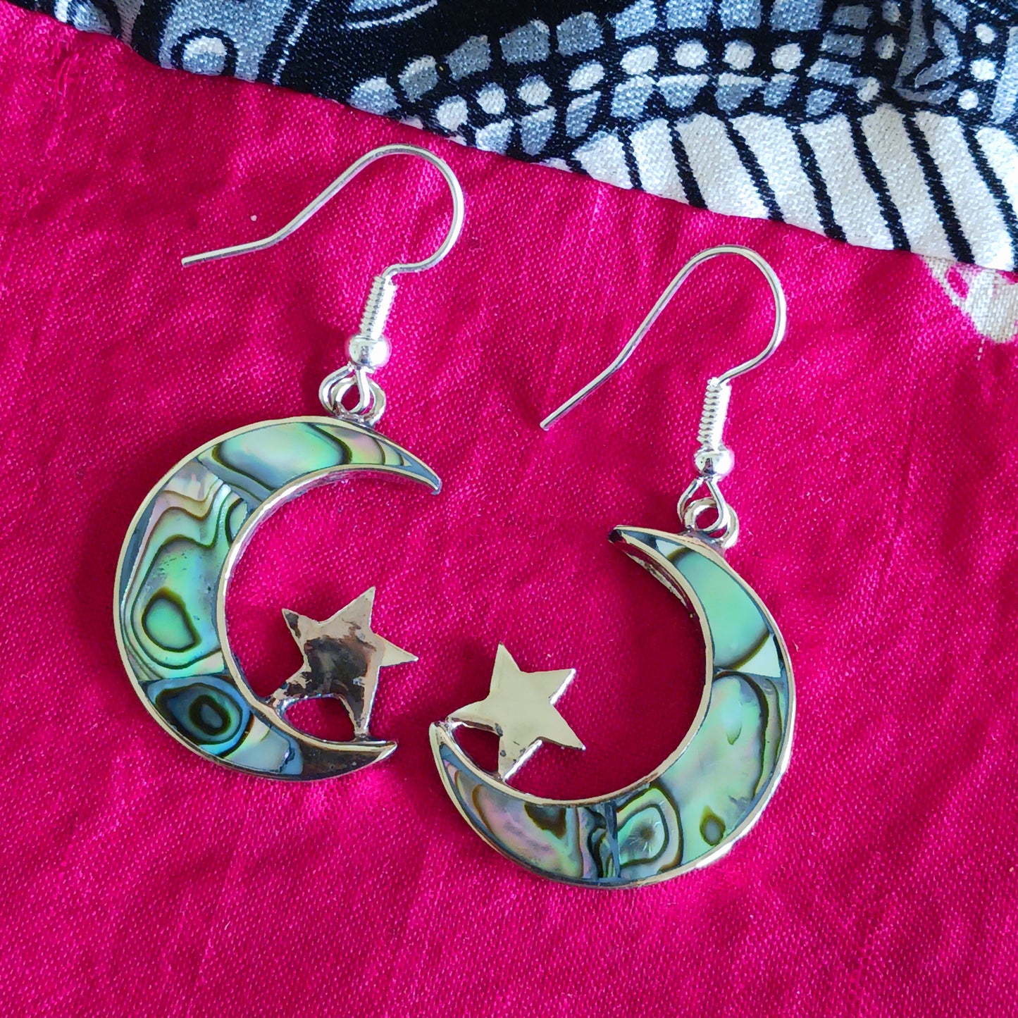These stunning painted abalone earrings are beautifully crafted into a moon and stars shape. The fixing are silver plated. The earrings come in a recycled sari gift pouch.