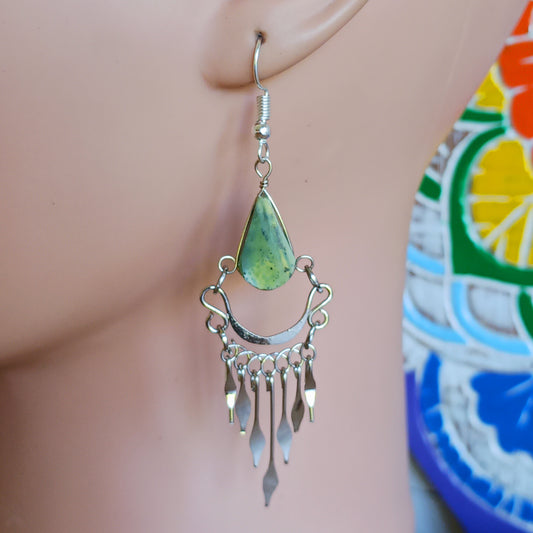 These beautiful hoop earrings incorporate a light green stone with Silver plated hooks. They have been hand made in Peru and are presented in a traditionally made pouch gift wrapped and ready to give☸