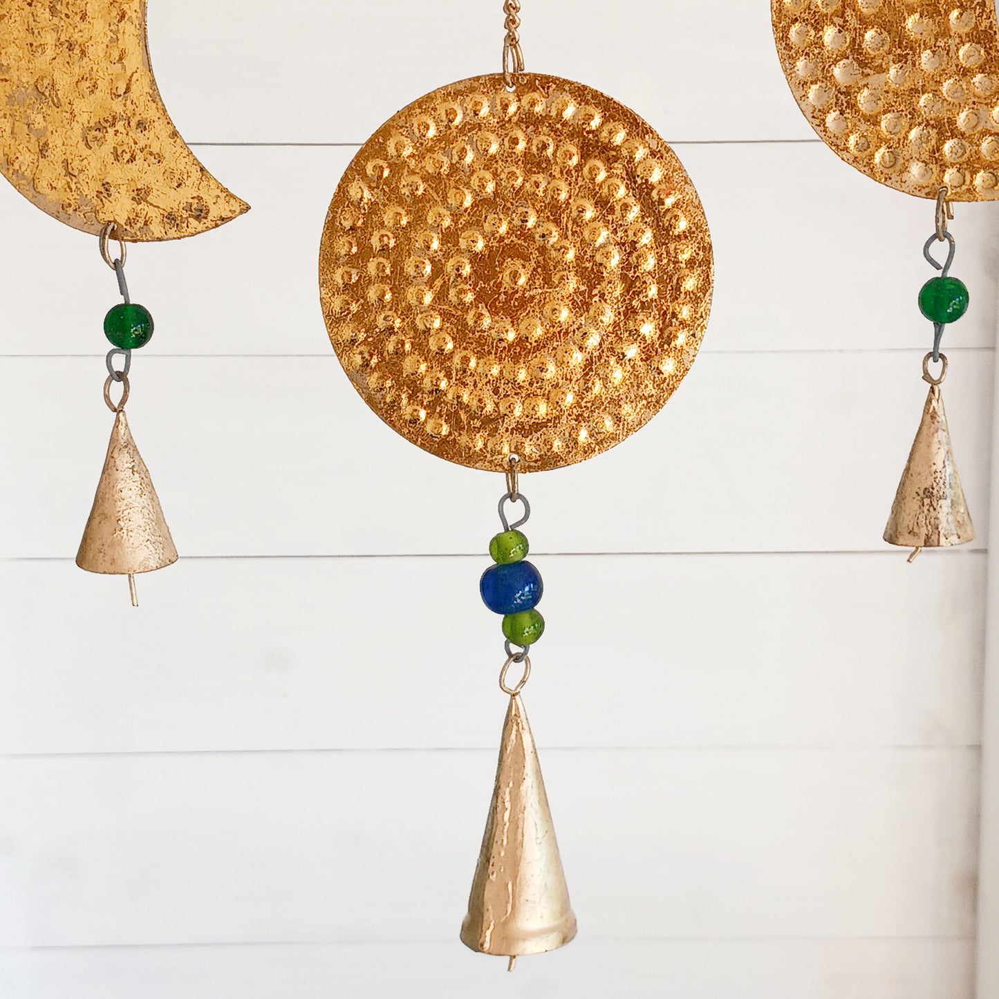 Add a little celestial beauty to your home with this unique brass Moon Phases Chimes. Made in India, it showcases the phases of the moon in stunningbrass, making it a striking piece for any space. Featuring intricate designs of each lunar phase, symbolizing the cycle of life and renewal.