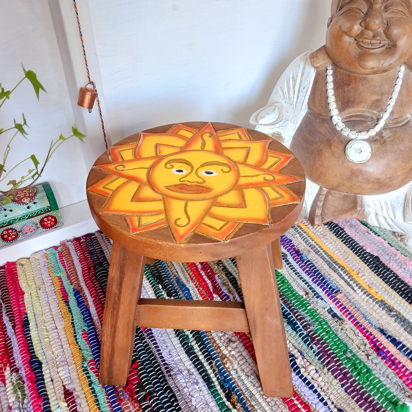 This lovely little handmade, carved and painted stool is Fairtrade from Thailand. It features a vibrant, radiant sun carving with beautiful gold detailing. These cheeky little items are very versatile making great stools for little bums or as tiny tables to add accent to your home. They can also be very useful as a step for those hard to reach high up shelves or even just to put your feet up on, and due to their small form are easy to store.