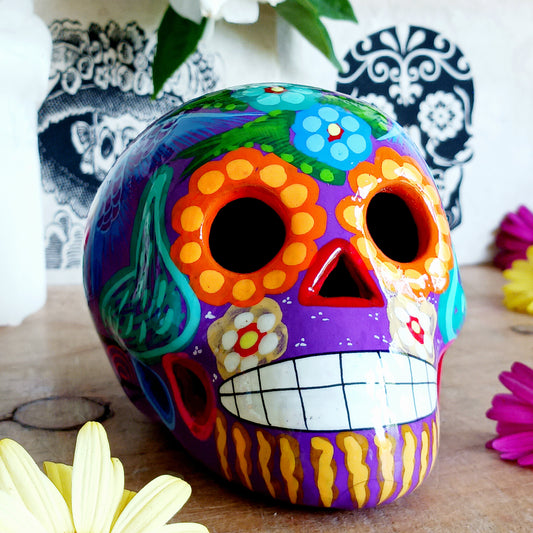 These fun ceramic sugar skull ornaments have been beautifully painted in bright colours and finished with a high shine glaze. They are a popular item during Día de Los Muertos or Day of the Dead festivities, held in Mexico every November to celebrate welcoming the souls of their deceased relatives back for a time of food, drink and celebration.