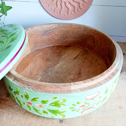 Bring a touch of traditional Indian craftsmanship to your home with this beautiful Handmade Indian Wooden Peacock Decorative Box. Expertly crafted from wood and hand-painted by skilled artisans, this charming round storage box features an elegant peacock design on the pull-off lid, symbolizing beauty, grace, and prosperity.
