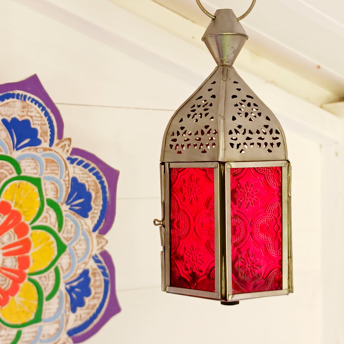 These small glass lanterns come in wonderful colours, featuring an intricate embossed pattern. They have a small hinged door that closes with a sliding catch. The small handle on the top is great for hanging the lanterns around your home. Perfect for adding a touch of warmth to your space.