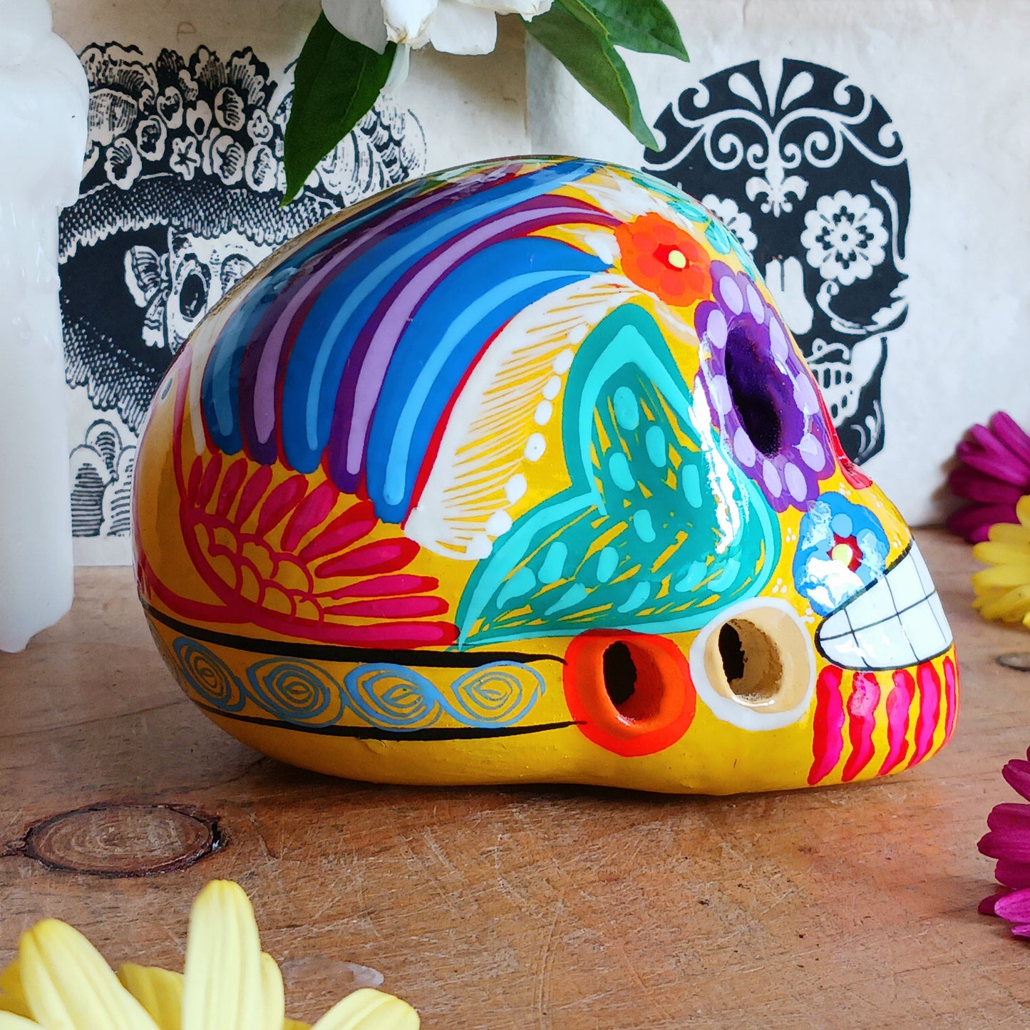 These fun ceramic sugar skull ornaments have been beautifully painted in bright colours and finished with a high shine glaze. They are a popular item during Día de Los Muertos or Day of the Dead festivities, held in Mexico every November to celebrate welcoming the souls of their deceased relatives back for a time of food, drink and celebration.