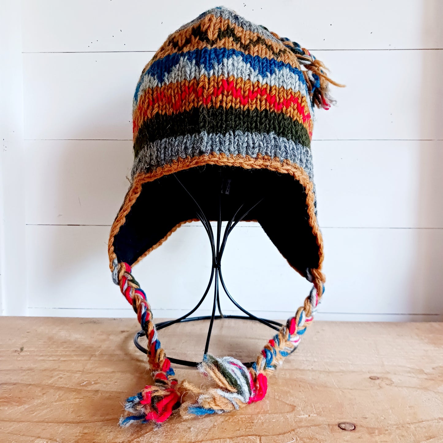 Stay cozy and stylish with our handmade chunky wool earflap hats, crafted in Nepal by skilled women artisans in Kathmandu. Each hat is 100% pure wool and features a soft polar fleece lining for extra warmth and comfort. Perfect for cold winter days, outdoor adventures, or adding a touch of handmade charm to your look.