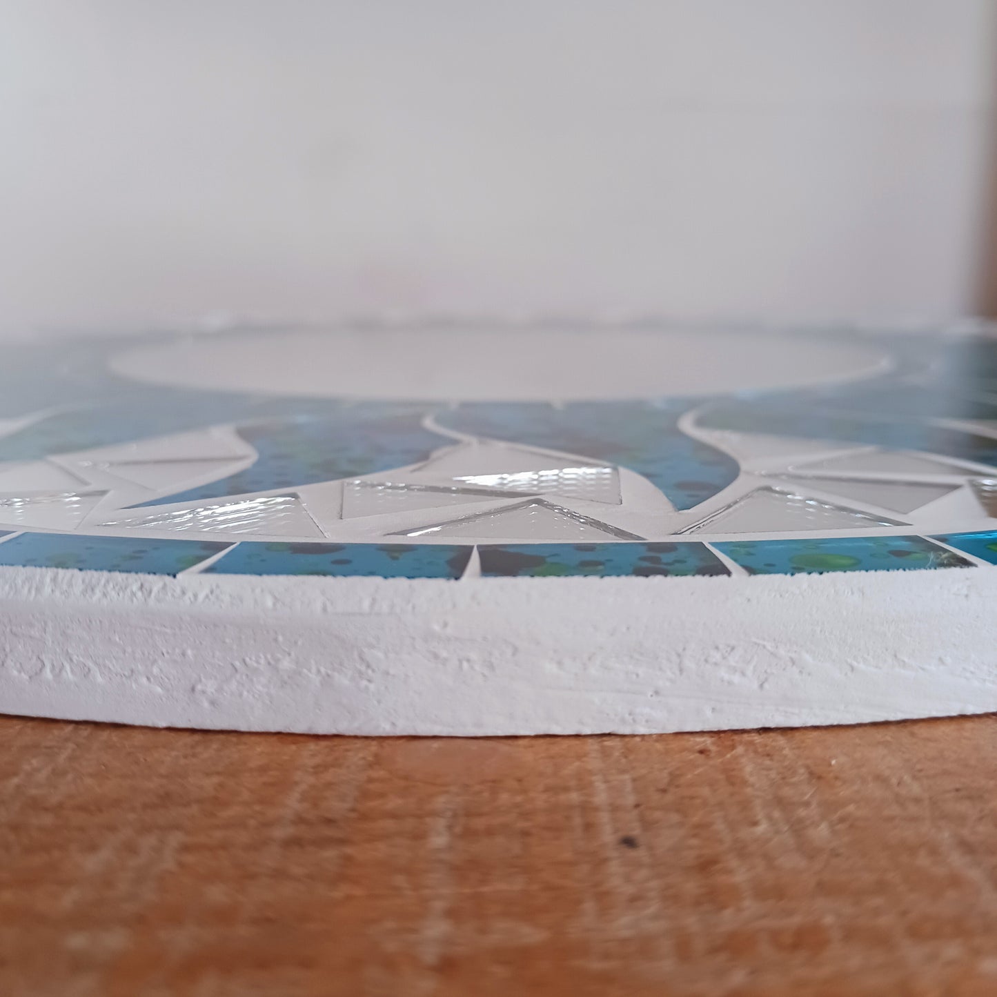 Add warmth, energy, and artistic charm to your home with this beautiful Vibrant Turquoise Mosaic Sun Mirror. Designed with dazzling turquoise mosaic tiles arranged in a radiant sunburst pattern, this captivating wall accent instantly brightens any room.