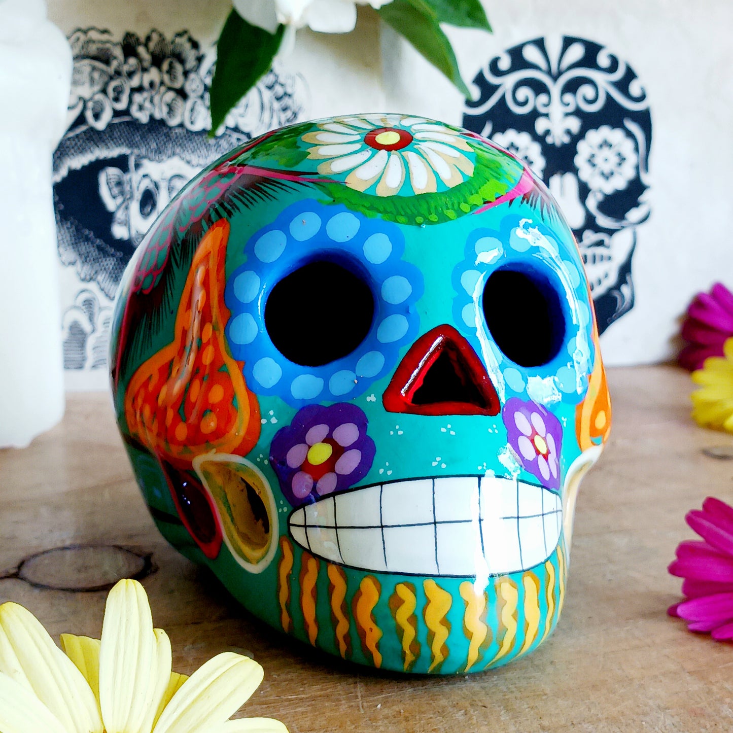 These fun ceramic sugar skull ornaments have been beautifully painted in bright colours and finished with a high shine glaze. They are a popular item during Día de Los Muertos or Day of the Dead festivities, held in Mexico every November to celebrate welcoming the souls of their deceased relatives back for a time of food, drink and celebration.