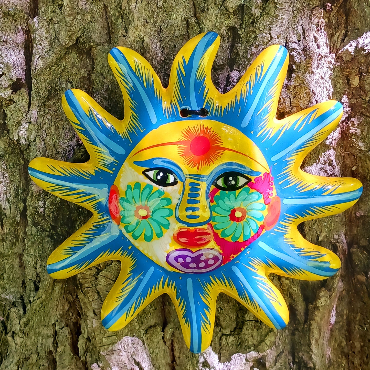 Bring a burst of colour and joy into your space with this sunny, vibrant wall plaque! Expertly hand-painted in the bold, traditional style of Xalitla, Guerrero, Mexico, this decorative piece radiates cultural charm. The vivid colors and striking glaze add depth and personality, making it a standout feature in any room. With two convenient holes for easy hanging, it’s ready to brighten your home with authentic folk art flair.