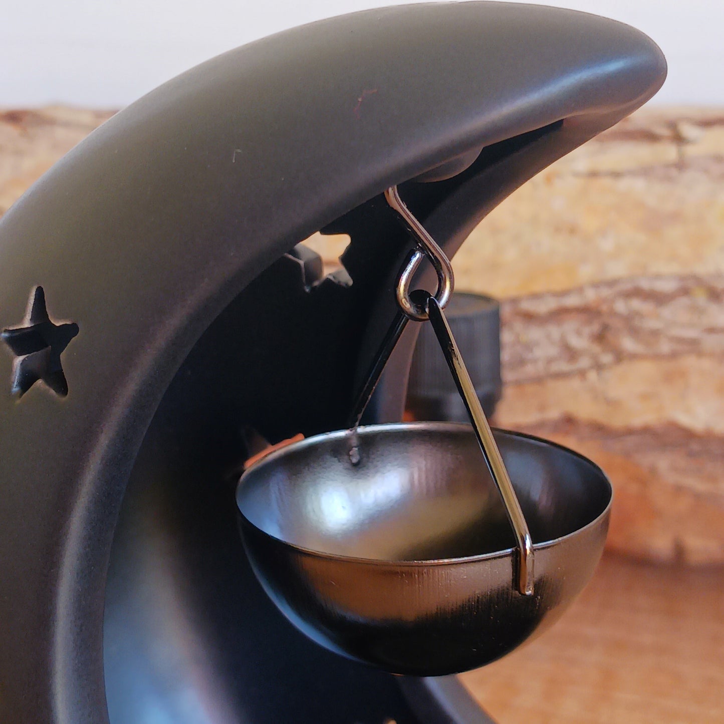 Bring a touch of midnight magic to your home with this black crescent moon oil burner, a beautifully designed piece that blends home fragrance with celestial décor. Featuring delicate star cut-outs, this oil burner casts a soft, glowing light while gently filling your space with the scent of your favourite fragrance or essential oils.