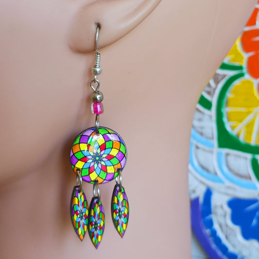 Colourful hippie style earrings featuring a vibrant mandala pattern design. Each pair is handmade in Peru and finished with silver plated hooks. Ideal for a night out or for dressing up your unique boho look!