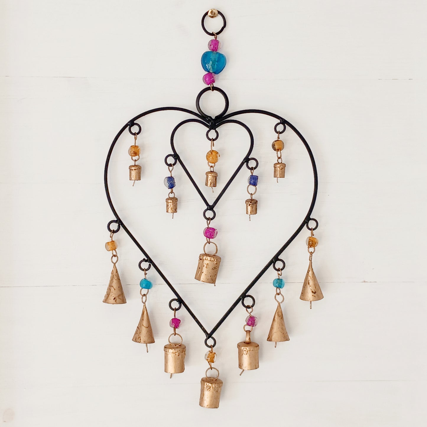 A delicate black finish windchime with two interconnected hearts surrounded by strings of multi-coloured beads and a combination of Indian brass bells.
Ideal for a sentimental gift and keepsake to mark a special occasion. The ideal engagement gift, to celebrate moving in together or a special anniversary.