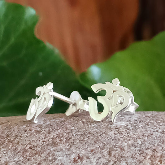 Om, a sacred mantra intoned at the beginning and end of prayers or used in meditation practices, is depicted in script in these stud earrings.