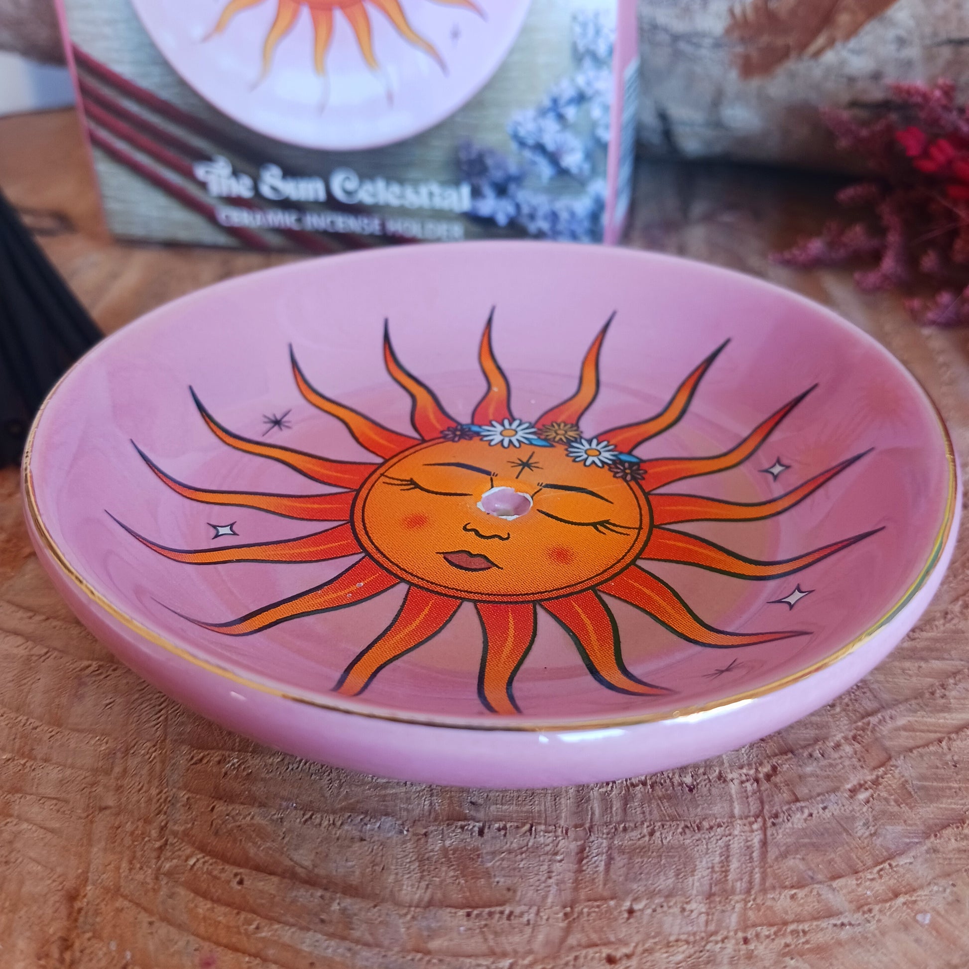 This modern incense stick holder features a lovely warm colourful sun design inspired by 'The Sun' tarot card. This ceramic dish provides a stylish and practical way to enjoy incense.