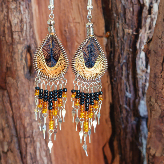 These beautiful and eye-catching earrings are handmade in Peru and feature an array of gorgeous colours. A woven teardrop, similar in style to a peacock feather, is finished with co-ordinating beads and silver embellishments. Ideal for a night out or for dressing up your boho look!