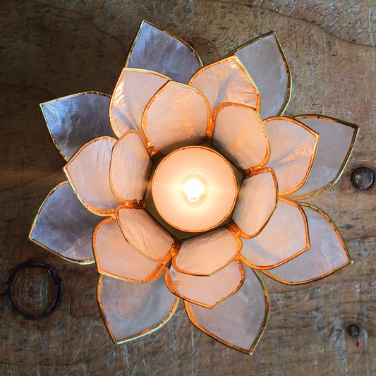 Elegant lotus candle holder made from Capiz shells. Fits 5.5cm candles. Fairtrade, handcrafted, perfect for peaceful indoor & outdoor ambiance.