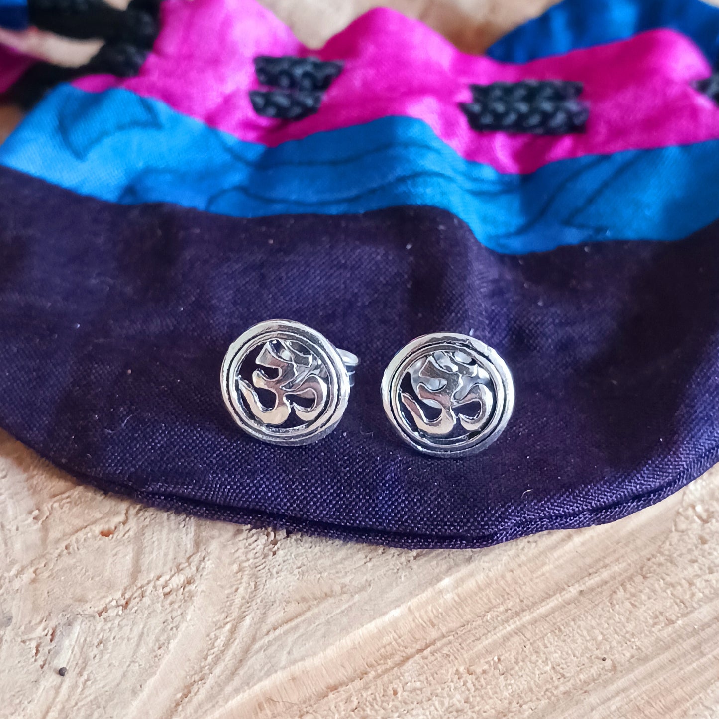 These small Om earrings are 925 silver and feature an Om symbol enclosed in a circle. Measuring 6mm x 6mm, these lovely little earrings come gifted in a recycled sari gift pouch.