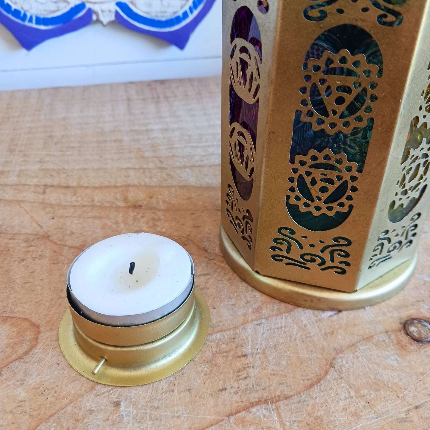 Discover the enchanting seven-sided standing lantern, each side beautifully illustrating one of the unique chakra symbols. Crafted from exquisite gold metal, this lantern not only adds a touch of elegance to any space but also features a convenient bottom turn-opening door that doubles as a candle holder tray.