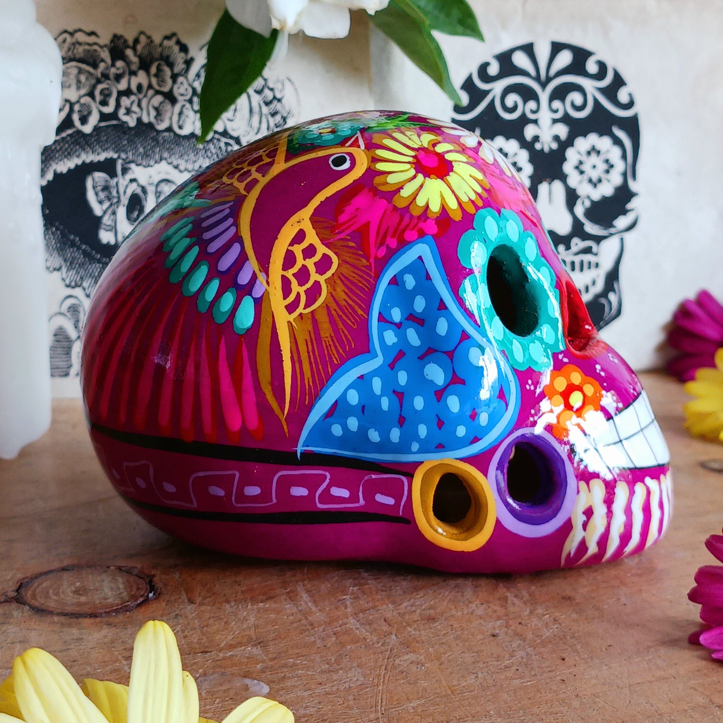 These fun ceramic sugar skull ornaments have been beautifully painted in bright colours and finished with a high shine glaze. They are a popular item during Día de Los Muertos or Day of the Dead festivities, held in Mexico every November to celebrate welcoming the souls of their deceased relatives back for a time of food, drink and celebration.