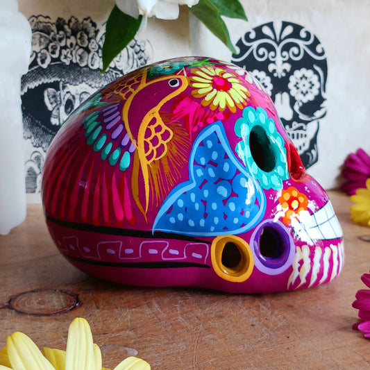 These fun ceramic sugar skull ornaments have been beautifully painted in bright colours and finished with a high shine glaze. They are a popular item during Día de Los Muertos or Day of the Dead festivities, held in Mexico every November to celebrate welcoming the souls of their deceased relatives back for a time of food, drink and celebration.