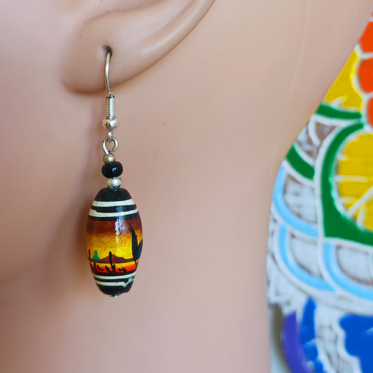 A stunning sunset design adorns this pair of earrings, hand painted on clay beads from Cusco, Peru. And no Peru design would be complete without some llamas added in! Each pair is carefully hand assembled in the Kent countryside and uses silver plated fixings.