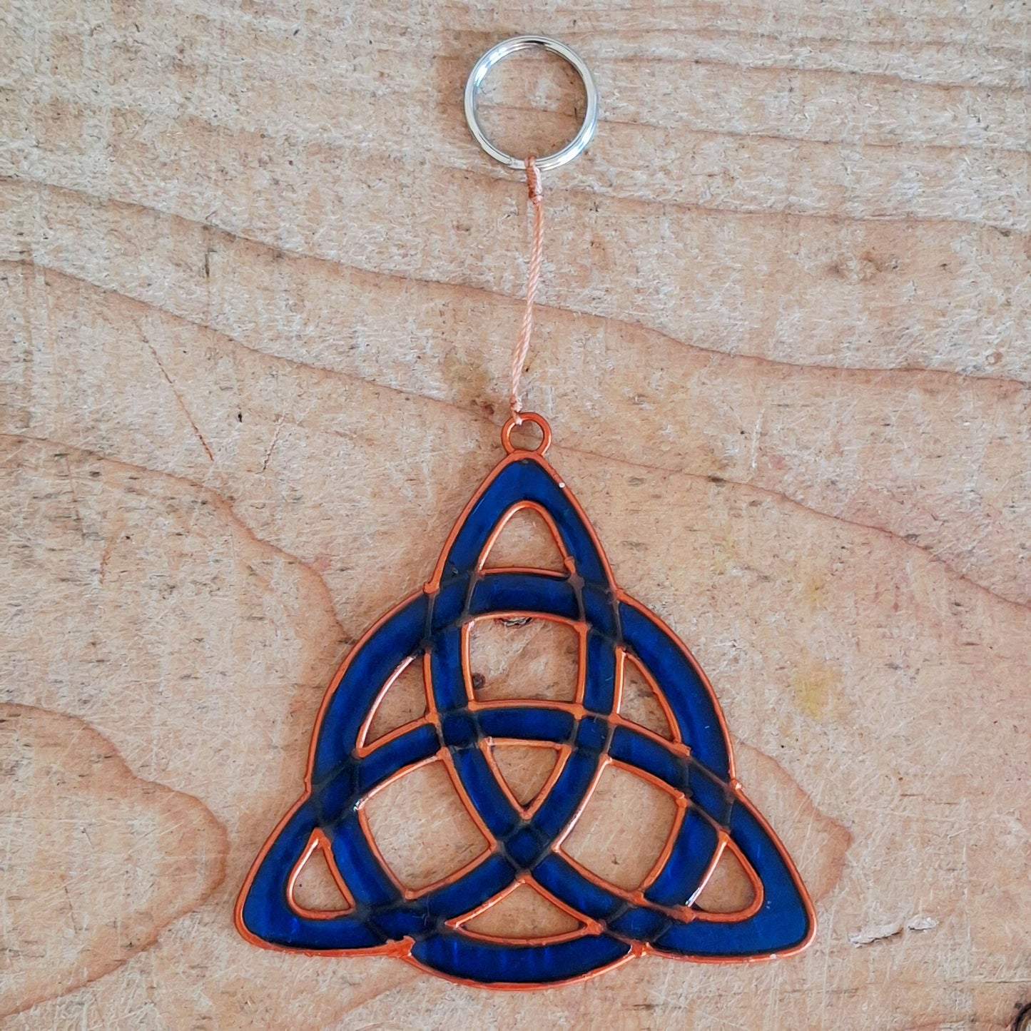 Invite the mystical energy of nature into the home with this little pagan suncatcher featuring a traditional triquetra design. Handcrafted in Bali, this enchanting piece is sure to infuse any space with a touch of earthly charm.