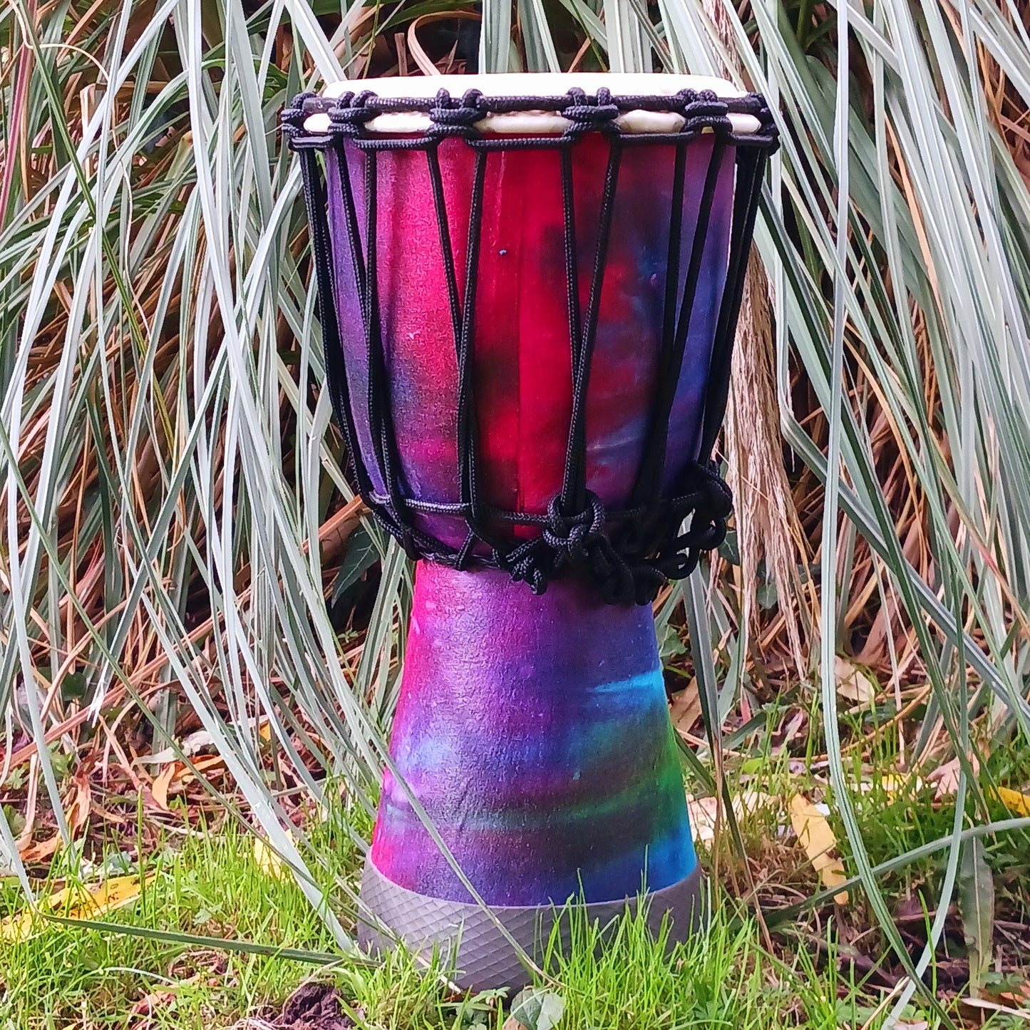 Awaken your rhythm with this handcrafted Rainbow Wooden Djembe from the heart of Indonesia. Standing 30cm tall with a 6–8" head, this compact drum carries the earth’s natural resonance and the spirit of Balinese ceremony. Wrapped in vibrant rainbow sarong fabric and finished with a protective varnish, it radiates healing colour and joyful energy.
