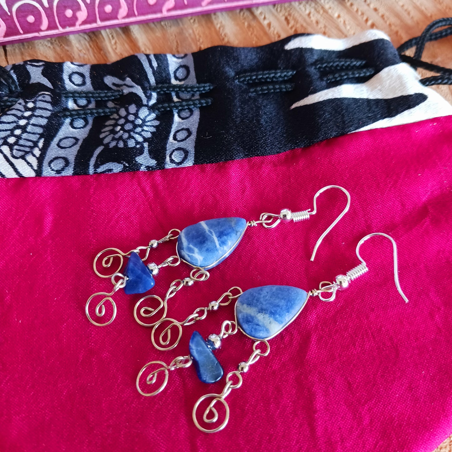 These beautiful spiral earrings feature a lapis lazuli stone and three spirals. They dangle really nicely when worn, and are easy to dress up or down. The hooks are made from sterling silver so will be something that you can wear season after season.