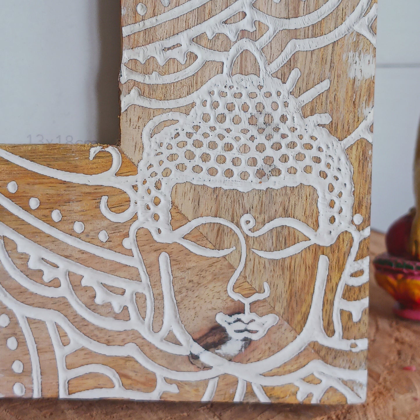 Made in India from sustainably sourced mango wood, these lovely picture frames bring warmth, character, and meaning to any space. Each one is carefully carved or painted with spiritual and cultural designs that go beyond decoration holding deep symbolism and tradition. The small Buddha in the corner is a peaceful presence that represents wisdom and enlightenment. Ideal for meditation spaces, yoga studios, or anyone seeking a sense of calm.
