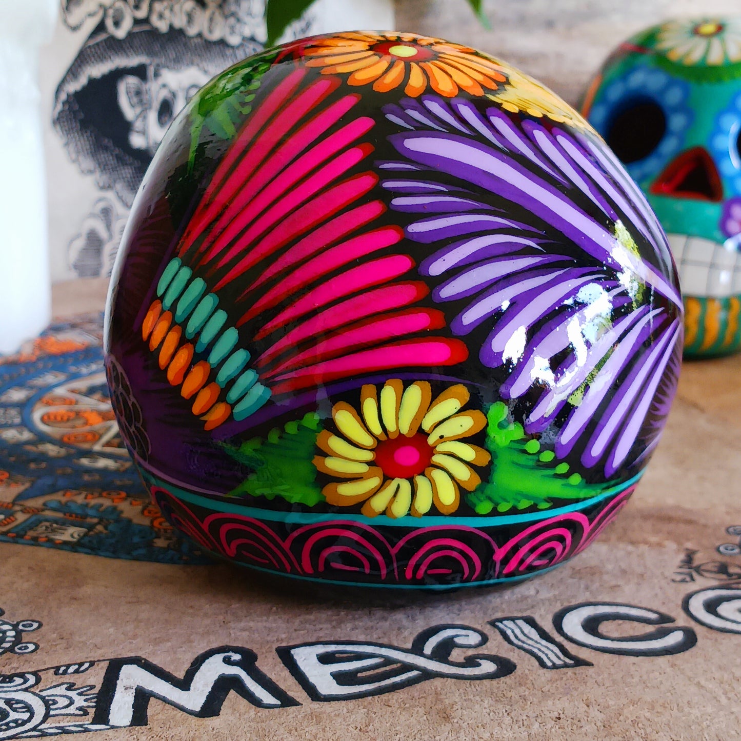 These fun ceramic sugar skull ornaments have been beautifully painted in bright colours and finished with a high shine glaze. They are a popular item during Día de Los Muertos or Day of the Dead festivities, held in Mexico every November to celebrate welcoming the souls of their deceased relatives back for a time of food, drink and celebration.