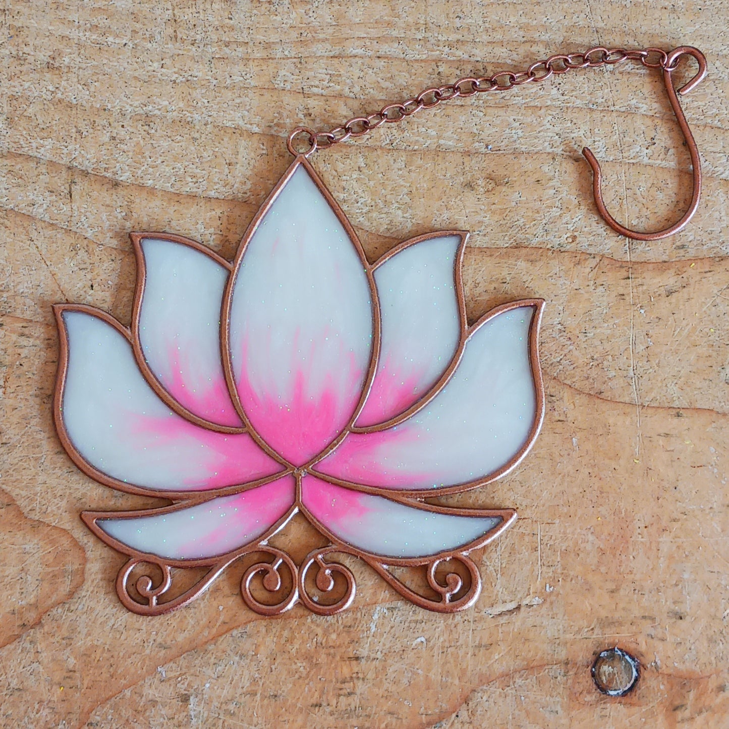 Bring a touch of tranquility to your space with this beautifully crafted lotus flower window hanger. Made from vibrant coloured glass and outlined in sleek metal framing, this piece combines simplicity and elegance. When sunlight passes through, it creates a radiant, uplifting display of color. Hang it in any window to inspire peace, mindfulness, and beauty in your home or workspace.