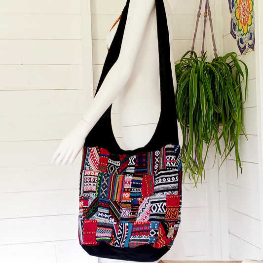 This shoulder bag is a great size which makes it ideal for taking shopping or carrying to class. It has a handy inside zipped pocket, perfect for your phone or purse. The design is made from a patchwork of the popular Thai weave material and comes fully lined with a secure zip fastening.