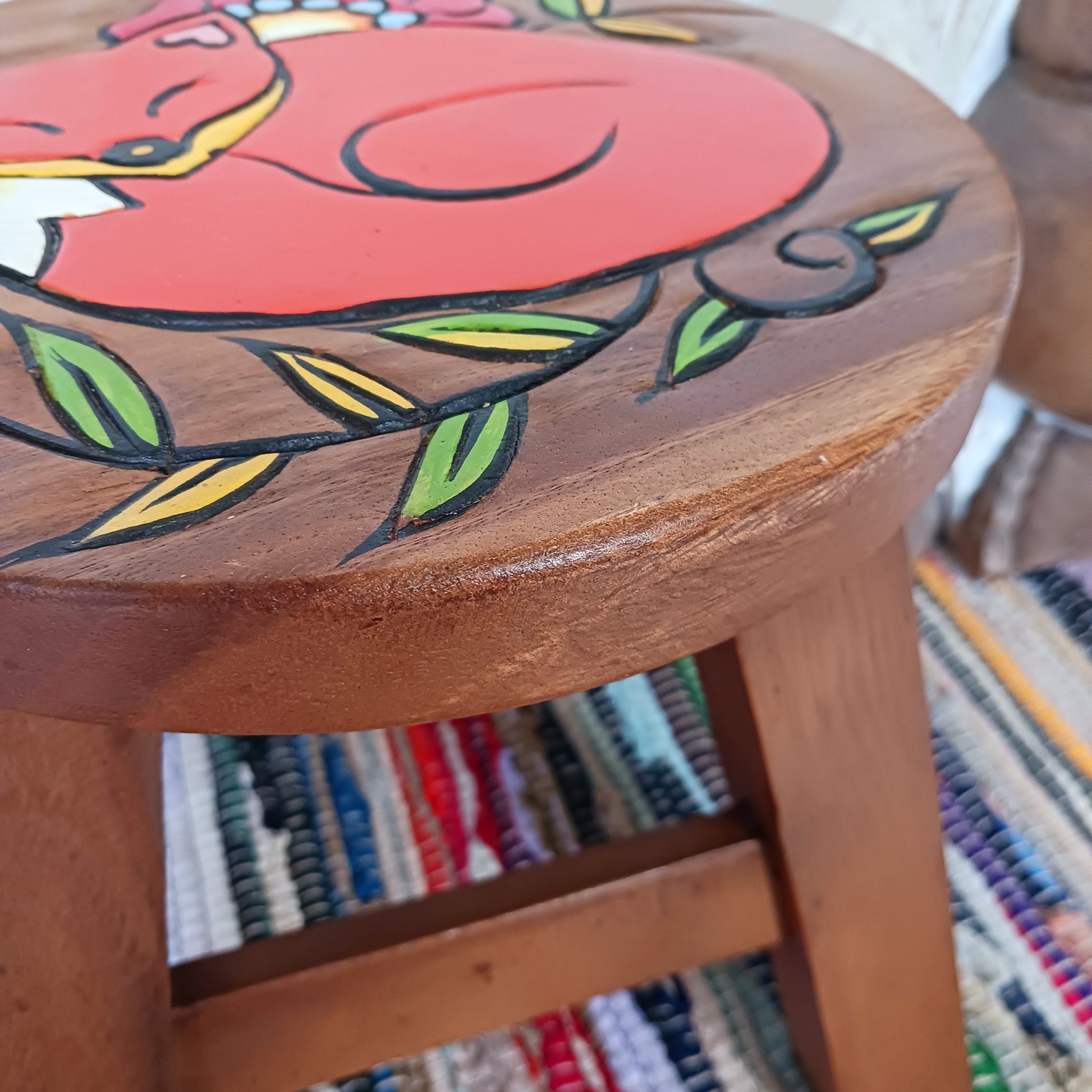 This lovely little handmade, carved and painted stool is Fairtrade from Thailand. The top of this stool has been carefully hand carved and then painted to show a peacefully curled, sleeping fox surrounded by a flower and leaves. These cheeky little items are very versatile making great stools for little bums or as tiny tables to add accent to your home.