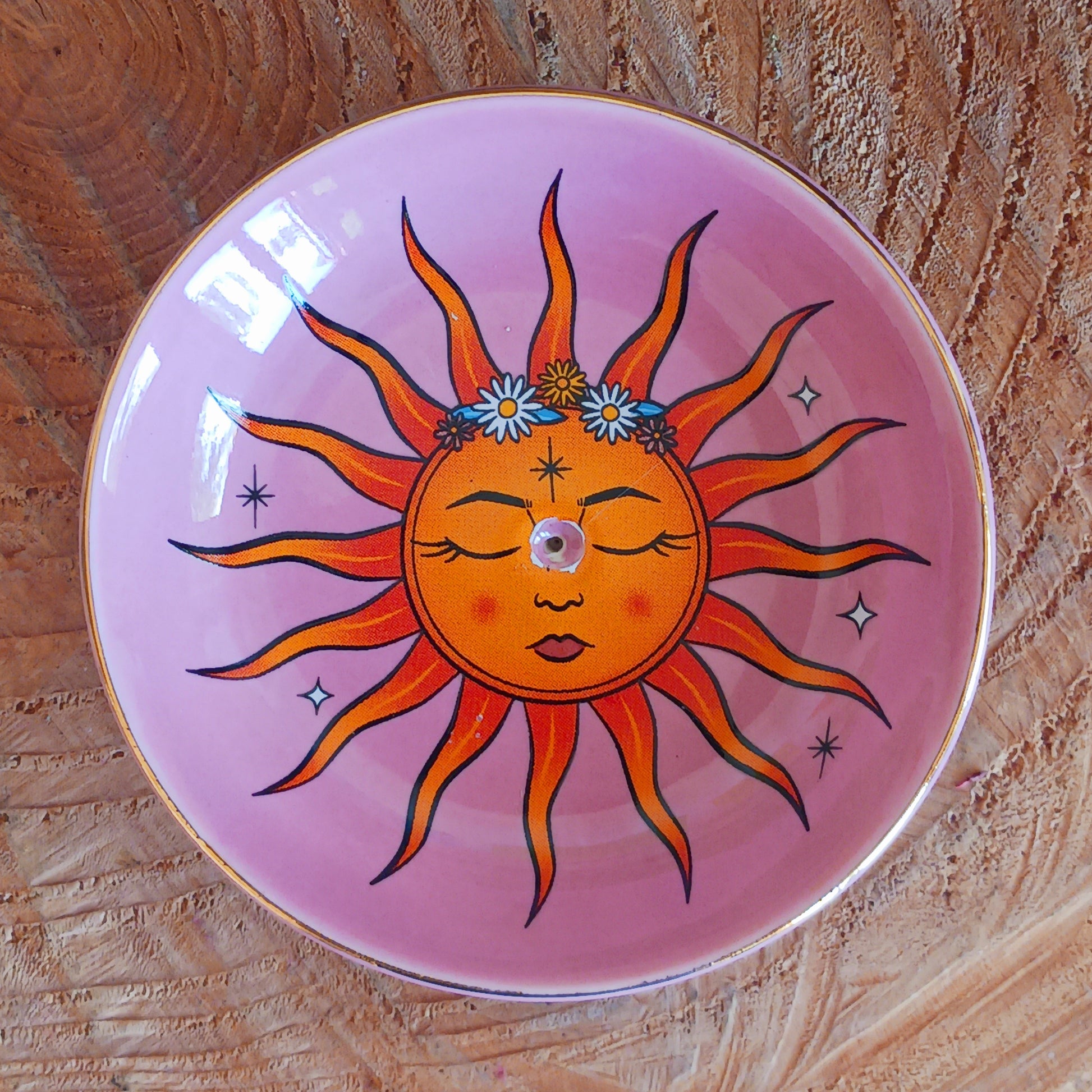 This modern incense stick holder features a lovely warm colourful sun design inspired by 'The Sun' tarot card. This ceramic dish provides a stylish and practical way to enjoy incense.