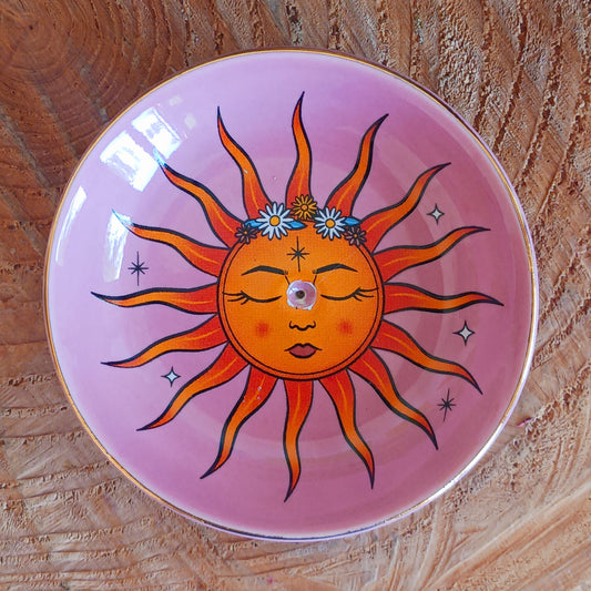 This modern incense stick holder features a lovely warm colourful sun design inspired by 'The Sun' tarot card. This ceramic dish provides a stylish and practical way to enjoy incense.