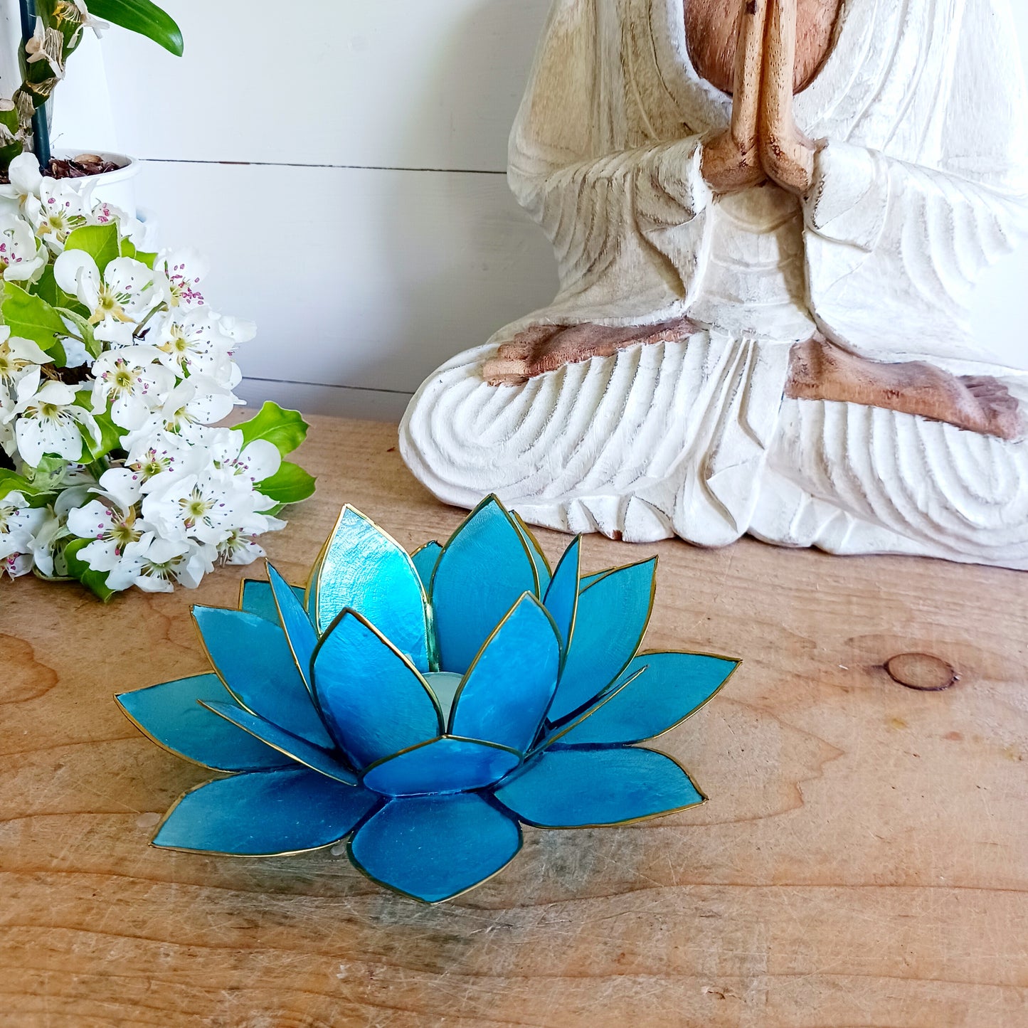 The Lotus Flower is a symbol of achieving enlightenment, peacefulness and spirituality. This beautiful candle holder can be fitted with tealight candles or slightly larger candles. The diameter of the middle is roughly 5.5cm, so it will fit any candle with the same diameter.